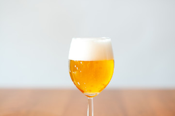 One glass of fresh beer with foam