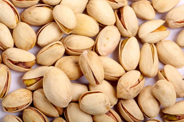 Unshelled roasted and salted cashew nuts isolated on white background