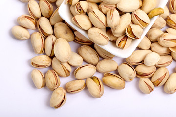 Unshelled roasted and salted cashew nuts isolated on white background