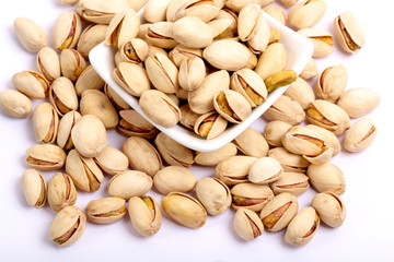 Unshelled roasted and salted cashew nuts isolated on white background