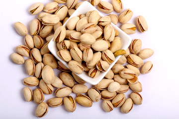 Unshelled roasted and salted cashew nuts isolated on white background