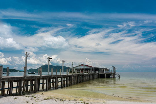 Tropical landscape of Koh Rong Samloem island with white pier and beautiful beach in the distance. Cambodia, asia.