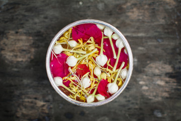 Water and fresh flower in a bowl  on old wood background, Songkran  festival in Thailand