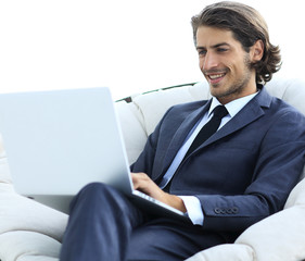 close-up of smiling businesswoman working with laptop in living room.