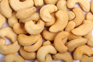 Unshelled roasted and salted cashew nuts isolated on white background