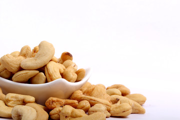 Unshelled roasted and salted cashew nuts isolated on white background