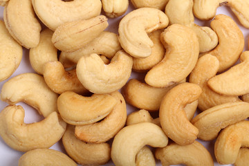 Unshelled roasted and salted cashew nuts isolated on white background