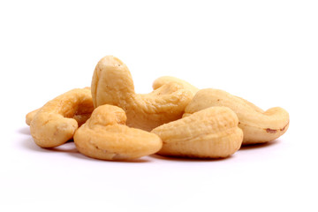 Unshelled roasted and salted cashew nuts isolated on white background