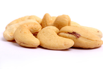 Unshelled roasted and salted cashew nuts isolated on white background