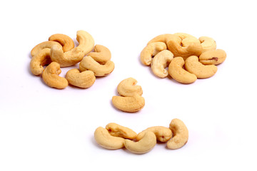 Unshelled roasted and salted cashew nuts isolated on white background