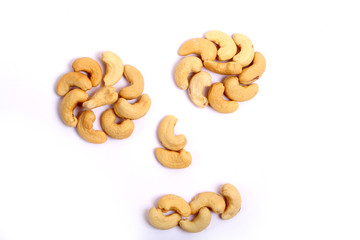Unshelled roasted and salted cashew nuts isolated on white background