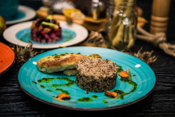 buckwheat porridge with a cutlet on a blue plate. Buckwheat cereal with schnitzel.
