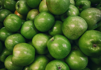 Deep green apples in store