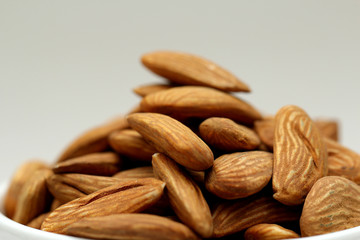 Almond mamra giri isolated. Group of almond nuts isolated on white background. Full depth of field