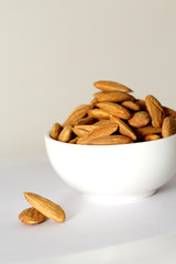 Almond mamra giri isolated. Group of almond nuts isolated on white background. Full depth of field