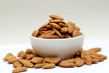 Almond mamra giri isolated. Group of almond nuts isolated on white background. Full depth of field
