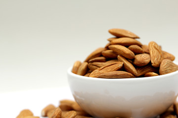 Almond mamra giri isolated. Group of almond nuts isolated on white background. Full depth of field