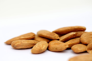 Almond mamra giri isolated. Group of almond nuts isolated on white background. Full depth of field