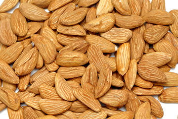 Almond mamra giri isolated. Group of almond nuts isolated on white background. Full depth of field