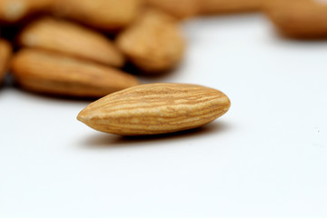 Almond mamra giri isolated. Group of almond nuts isolated on white background. Full depth of field