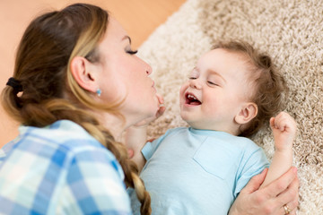 Mother with baby son playing together at home