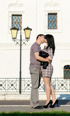 young couple kissing on the street