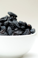 black raisins on white background
