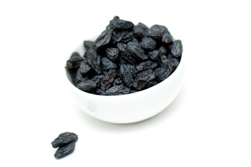 black raisins on white background