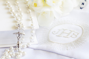 First holy communion symbol background concept with rosary and flowers
