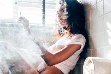 Fashion portrait of  beautiful woman sexy slim body smoking cigarette