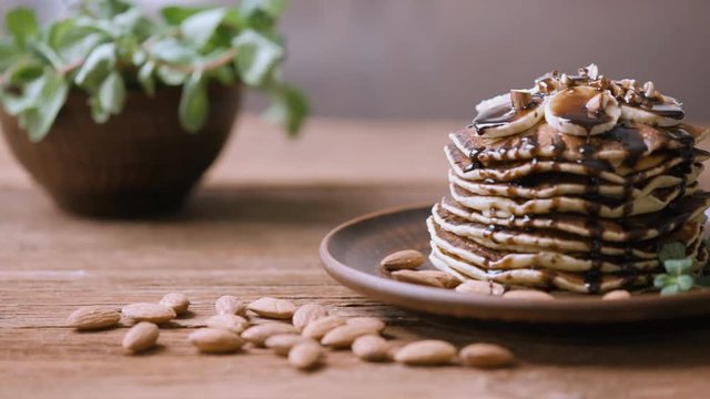 Homemade pancakes with banana, almonds and chocolate . 