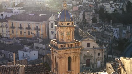 Ragusa Ibla, Sicily, Italy. Maiolica roofed bell tower of Santa Maria dell'Itria church at sunset - Powered by Adobe