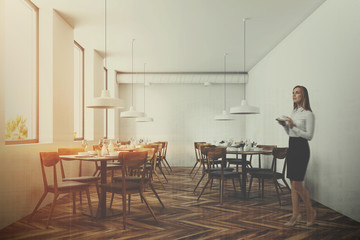 Fototapeta na wymiar White modern cafe interior, beautiful woman