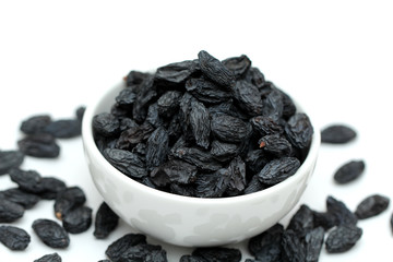 black raisins on white background