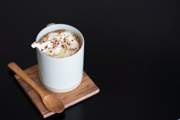 Mocha hot coffee with whipped cream on table.