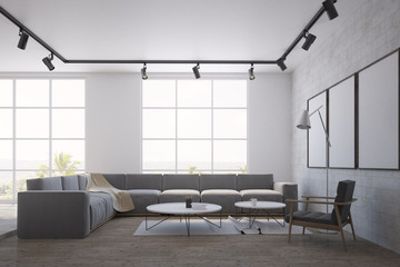 Poster gallery in a white brick living room, side