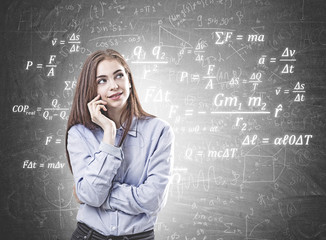 Dreamy young woman in a blue shirt, formula