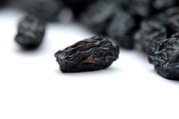 black raisins on white background