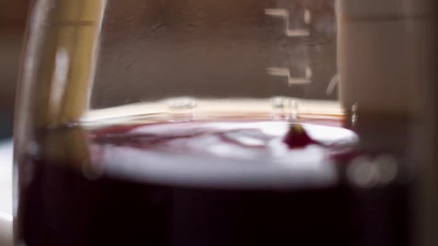 Slo-mo close-up of the last few drops of coffee dripping into the glass pot.