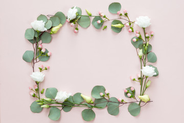 Square flower frame of wreath with pink inflorescence, buds, branches and eucalyptus green leaves isolated on light background, top view flat lay