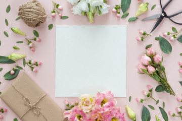 Flat lay of vintage gift box of Kraft eco paper with flower frame wreath on pink background, top...