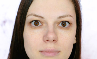 Closeup young brunette woman looking at the camera.