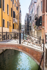 Fototapeta na wymiar Bridge over small venetian canal, Venice, Italy