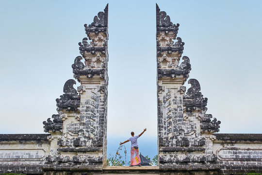 Man is standing in the gate of Lempuyang temple on Bali isalnd, Indonesia