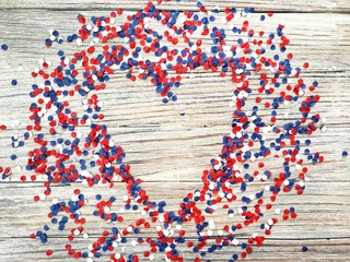 American independence Day, celebration, patriotism and holidays concept - flags and stars on the 4th of July party on top on wooden background