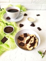 cheesecakes pancake with chocolate syrup on white plate with coffee on wooden table with runner