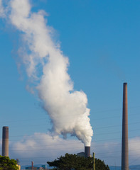 Steam and smoke coming out of a smoke stack
