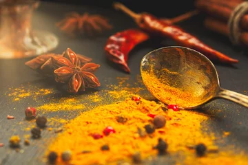 Foto op Plexiglas Wooden table of colorful spices © alefat