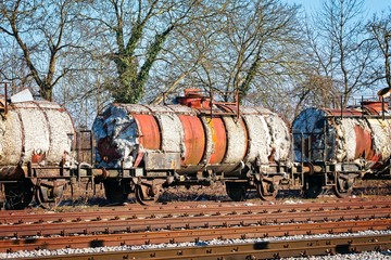 Degraded wagons with asbestos insulation on the side track of a local railway station waiting to be...