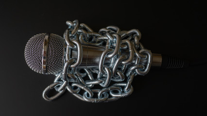 Microhpone and chain. Freedom of the press is at risk concept - World press freedom day concept